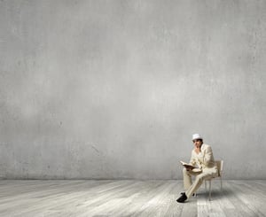 Young businessman sitting in chair with book in hands